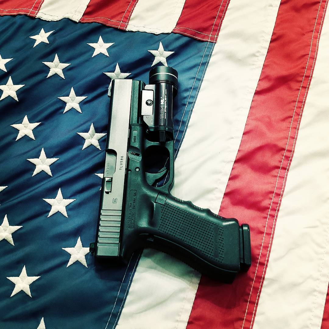hand gun sitting on top of USA flag